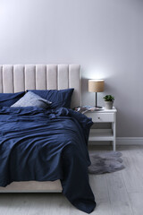 Canvas Print - Bed with stylish silky linens in room