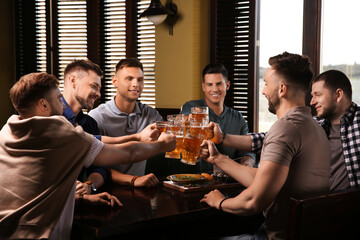 Poster - Friends clinking glasses with beer in pub