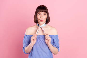 Poster - Photo of amazed shocked young woman hold hands scarf neck fix isolated on pastel pink color background