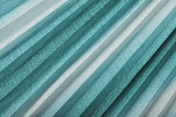 shiny seagreen textile  background,  turquoise pleated cloth as creative backdrop,   blue beautiful  bright material,  turquise  sea green colour of fabric, striped cloth