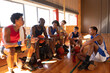 © Wavebreak Media - Diverse male basketball team and coach resting after match