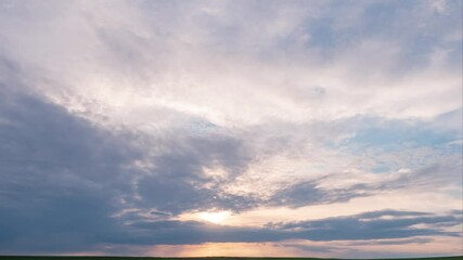 Wall Mural - Majestic sunset or sunrise landscape. 4K Time lapse of Amazing light of nature cloudscape sky and Clouds moving away rolling colorful sunset clouds