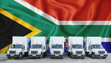 South Africa Flag In The Background. Five New White Trucks Are Parked In The Parking Lot. Truck, Transport, Freight Transport. Freight And Logistics Concept