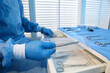 © New Africa - Doctor putting medical forceps into drawer indoors, closeup. Table with different surgical instruments