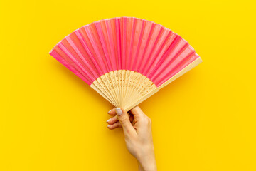 Wall Mural - Hand fan made of bamboo and paper in female hand