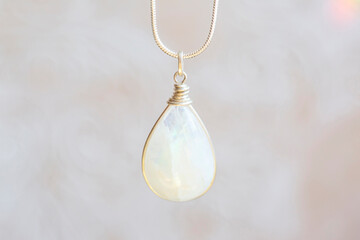 Wall Mural - Mineral moon stone sterling silver simple pendant on neutral background