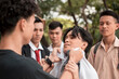 A bunch of high school delinquents bully a smaller boy. One bully grabs him by the collar. Emotional and physical abuse issues in teenagers.
