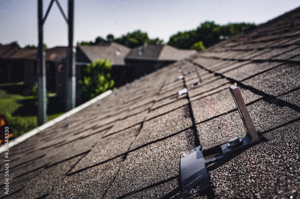 Residential asphalt shingle roof with metal anchors installed for the ...