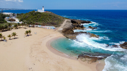 Aerial view of the lonely beach of Poza del Obispo and Arecibo Lighthouse and Historical Park Puerto Rico