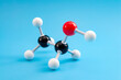 Molecular structure of chemical compounds and organic chemistry concept with educational plastic model of ethanol molecule isolated on blue background
