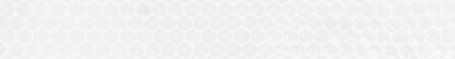 Wall Mural - White background texture of honeycombs with fresh raw honey.