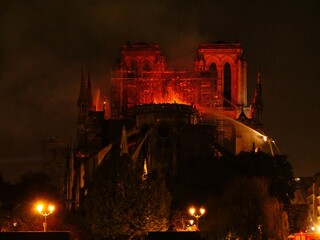 Wall Mural - Notre Dame de Paris burning in the night. Paris, France, the Monday 15th April 2019.