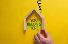 Diversity, Inclusion, Belonging And Belong Symbol. Businessman Builds A Model Of A Wooden House. Words 'You Belong Here' On A Beautiful Yellow Background. Diversity And You Belong Here Concept.