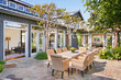© Trinette Reed/Stocksy - Private courtyard with dining room table
