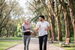 © sofiko14 - Positive young people in sport clothes running together at morning green park. Handsome muslim husband and charming wife in hijab training actively outdoors.