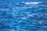 Fototapeta  - Calm sea water surface texture with splashes and waves. Abstract nature background. Background of aqua ocean water surface.