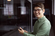 © wavebreak3 - Portrait of smiling asian businessman standing in empty office using tablet