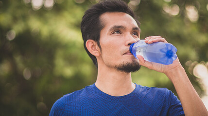 Wall Mural - Asian man drink water outdoor sport exercise