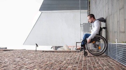 Wall Mural - man in wheelchair rolling up a wall