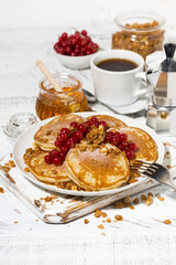 Sticker - delicious pancakes with berries and honey for breakfast on white table, vertical