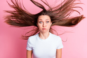 Wall Mural - Photo of funky funny silly playful woman with flying hair hold breath fooling around isolated on pink color background