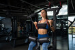 © nazarovsergey - Girl doing exercises for back muscles on strength machines at gym