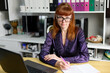 High resolution photo caucasian woman manager in dark shirt in office with laptop working