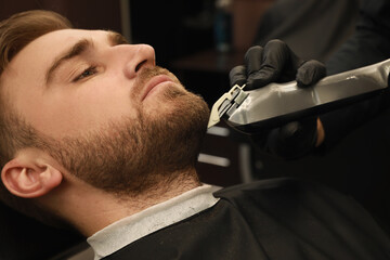 Wall Mural - Professional hairdresser working with client in barbershop, closeup