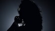 © stockbusters - Silhouette pretty woman posing camera in dark. Passionate woman touching hair