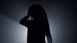 © stockbusters - Silhouette sexy girl dancing in darkness. Beautiful woman touching hair.