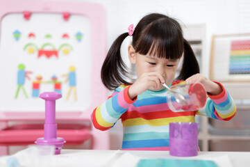 Wall Mural - young girl pretend playing food preparing at home