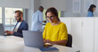 © TommyStockProject - Caucasian woman working in modern office holding documents using computer