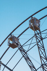 Wall Mural - Ferris wheel cabins against the background of the evening blue sky