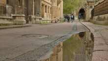 Tilting Shot From Puddle To Kings College Chapel 