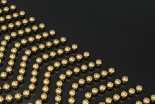 A Background Of Strands Of Gold Beads On A Black Surface. The Beads Are Arranged Diagonally. 3d Illustration.