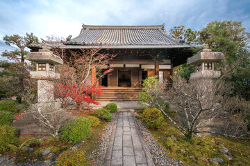 Wall Mural - Ancient, small Buddhist shrine with stone lamps and small Japanese garden in front of it in Arashiyama district of Kyoto, Japan.