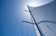 © Rawf8 - Yacht sails on clear blue sky background. Sailing with the wind at open sea ocean, summer holidays