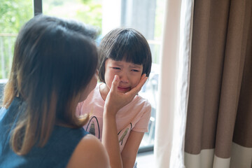 Wall Mural - mother hit her kid, children crying, feeling sad, young girl unhappy, family violence concept, selective focus and soft focus