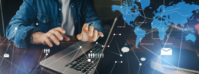 Male hands with laptop. Man working remotely at home. Concept of networking or remote work. Global business network.