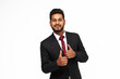 Portrait of young happy indian business man on white isolated background looking to the camera.