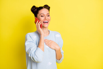 Poster - Photo of young attractive charming lovely pretty smiling girl talking on phone hold hand chest isolated on yellow color background