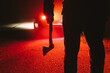 maniac killer near the car at night close-up. silhouette of a man with an ax in his hand at night in a fog.