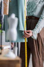 Cropped View Of Seamstress Measuring Blazer Near Mannequin