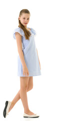 Wall Mural - Portrait of Teen Girl in Light Blue Dress Standing Half Turn