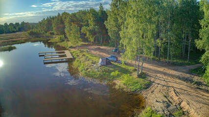 Aerial view Seliger lake in Ostashkovsky District of Tver Oblast Russia near Novgorod Oblast and Valdai Hills part of Volga basin. Summer sunny day. Dawn on beautiful Lake Seliger. Recreation and tour