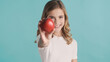 © Anton - Portrait of pretty teenager girl offering red apple and smiling