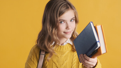 Wall Mural - Portrait of teenager student girl dressed in yellow sweater posi