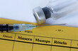 Impfung gegen Masern, Mumps und Röteln mit Impfpass, Spritze und Impfstoff