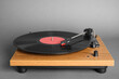 © New Africa - Modern vinyl record player with disc on grey background
