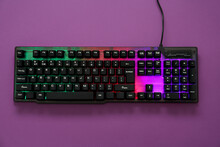 Modern RGB Keyboard On Purple Background, Top View